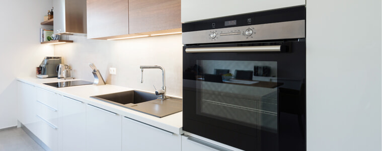 Sleek and Stylish: White Kitchen with Black Appliances